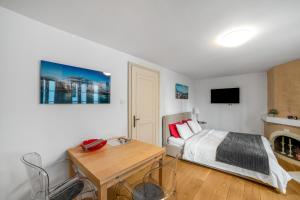 ein Schlafzimmer mit Bett, Tisch und Kamin in der Unterkunft Boël 5 studio in Genf