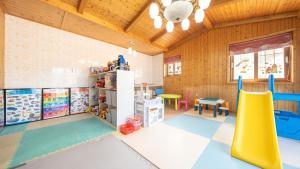 a play room with a slide and play equipment at Geoje Gaonara Pension in Geoje
