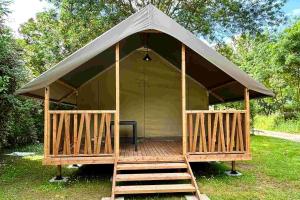 a large gazebo with a porch and a ladder at Lodge Mini-Wood in Les Rochettes