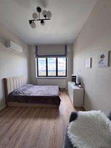 a bedroom with a bed and a window at comfortable apartment in Vancouver