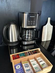 a coffee maker sitting on top of a counter at L'Ecrin des Myrtilles - Appartement cosy - Piscine et vue montagne - Alpes - Val d'Arly - Aravis et Beaufortain in Flumet