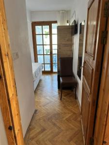 a hallway with a room with a bed and a chair at Akmonya Pansiyon in Eriklice