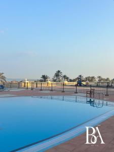 a large swimming pool with blue water at Bel Air -- Sea View Studio in Ras al Khaimah