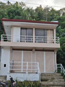 a house with a balcony on top of it at Imari's Apartment in San Isidro