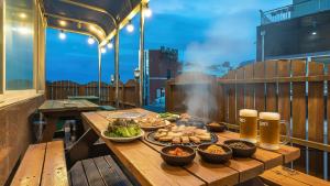 a table with food and drinks on a balcony at Geoje Blueberry Pet Pension in Geoje
