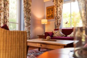 a living room with a couch and a table at Ferienhaus Möwe in Krienke