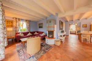a living room with a couch and a fireplace at Ferienhaus Möwe in Krienke