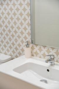 a bathroom with a white sink and a mirror at Villa 2 Quartos by WOT Lodge Soul in Ericeira +8 photos