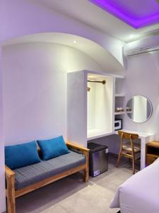 a bedroom with a couch and a table in a room at White Seeds Boutique Villas in Gili Trawangan