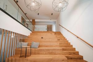 a staircase in a house with two benches and two lights at Trivrh Outdoor Hotel in Žirovnica +41 photos