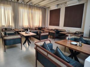 a conference room with tables and chairs and a board at Myspace Chindanur Comforts in Chitradurga +7 photos