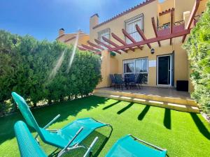 a yard with chairs and a house at Albatros Golf 2 - Islantilla in Isla Cristina