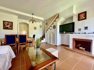 a living room with a fireplace and a tv at Albatros Golf 2 - Islantilla in Isla Cristina