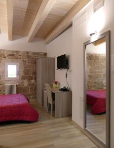 a room with two beds and a table with a mirror at B&B Il Campanile in Barletta