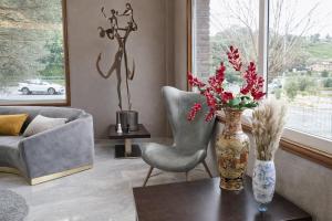 a living room with a vase of flowers on a table at Hotel San Rosendo in Ourense