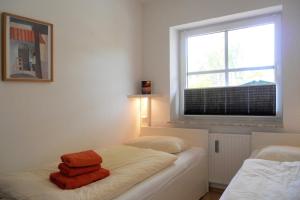 a bedroom with a bed with two towels on it at Rugstieg 8 Whg 2 in Wyk auf Föhr +8 photos