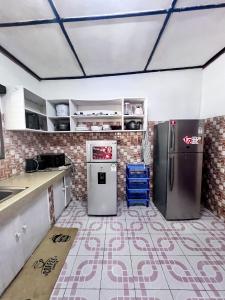 a kitchen with two refrigerators in a room at Cosy Garner Haven Watamu in Watamu +12 photos