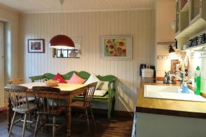 a kitchen with a table and a couch in a room at Midlum- Finnegan, EG in Midlum