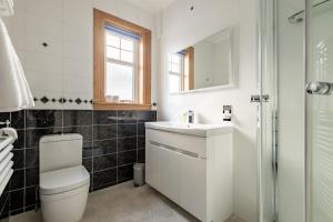 a bathroom with a sink and a toilet and a mirror at Avoncliffe in Crail +17 photos