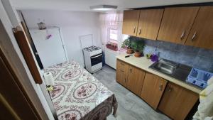 a small kitchen with a table and a sink at Casa Andrei in Slănic-Moldova