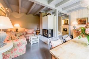 a living room with a couch and a fireplace at Bauernkate Seerose in Liepe
