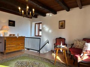 a living room with a chair and a dresser at Rustic villa with breathtaking views in Oprtalj