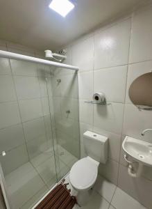 a bathroom with a shower and a toilet and a sink at Pousada Oxente Carioca in João Pessoa