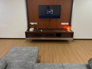 a living room with a tv and a couch at LIY Homestay in Gua Sai