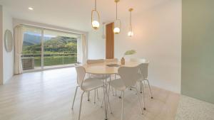 a dining room with a table and chairs and a window at Gapyeong Rowa River view Pension in Gapyeong