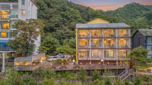 a large building with a lot of windows at Gapyeong Rowa River view Pension in Gapyeong