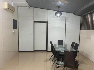 a conference room with a table and chairs in it at LIY Homestay in Gua Sai