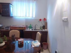 a kitchen with a table and a kitchen with a sink at Sun Power Villa in Hokandara South +6 photos