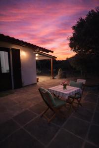 a table and chairs on a patio at sunset at Da Nonno Francesco in Teulada