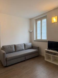 a living room with a couch and a television at Apartment Malpensa in Somma Lombardo +16 photos