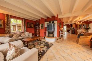 a living room with red walls and a fireplace at Ferienhaus Kranich in Krienke