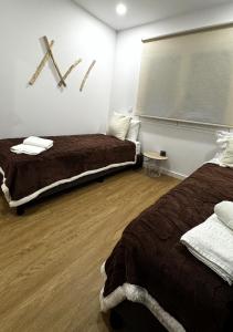 a bedroom with two beds and a x on the wall at S'apartments New in Leiria