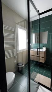 a bathroom with a toilet and a sink and a mirror at S'apartments New in Leiria