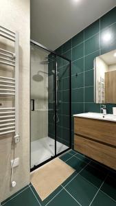 a bathroom with a glass shower and a sink at S'apartments New in Leiria +43 photos