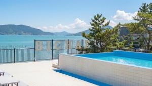 a swimming pool with a view of the water at Sacheon Bichae Pension in Sacheon