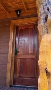 a wooden door on the side of a house at Premium Cabin in El Bolsón in El Bolsón