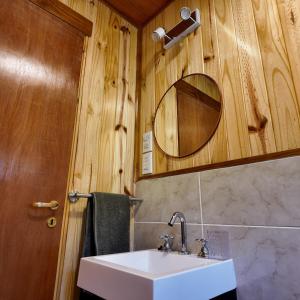 a bathroom with a sink and a mirror at Premium Cabin in El Bolsón in El Bolsón +9 photos