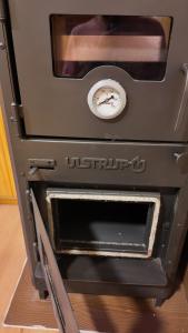 an old oven sitting on top of a wooden floor at Premium Cabin in El Bolsón in El Bolsón