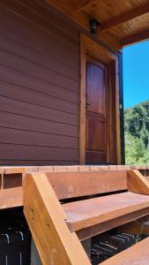a wooden porch of a house with a door at Premium Cabin in El Bolsón in El Bolsón