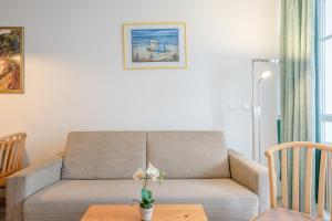 a living room with a couch and a table at Fewo 517, Seepark Sellin in Ostseebad Sellin