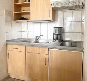 a kitchen with a sink and a coffee maker on the counter at Fewo 517, Seepark Sellin in Ostseebad Sellin