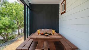 a wooden table with a bowl of fruit on a patio at Gapyeong Haneulsup Spa Pension in Gapyeong