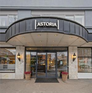 a entrance to a store with a sign on it at Home Hotel Astoria in Hamar