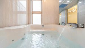 a bath tub with water coming out of it at Gapyeong Namian Pool Villa in Gapyeong