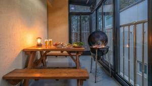 a table on a balcony with a grill at Gapyeong Namian Pool Villa in Gapyeong