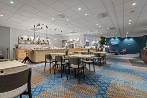 a dining area with tables and chairs in a restaurant at Home Hotel Astoria in Hamar